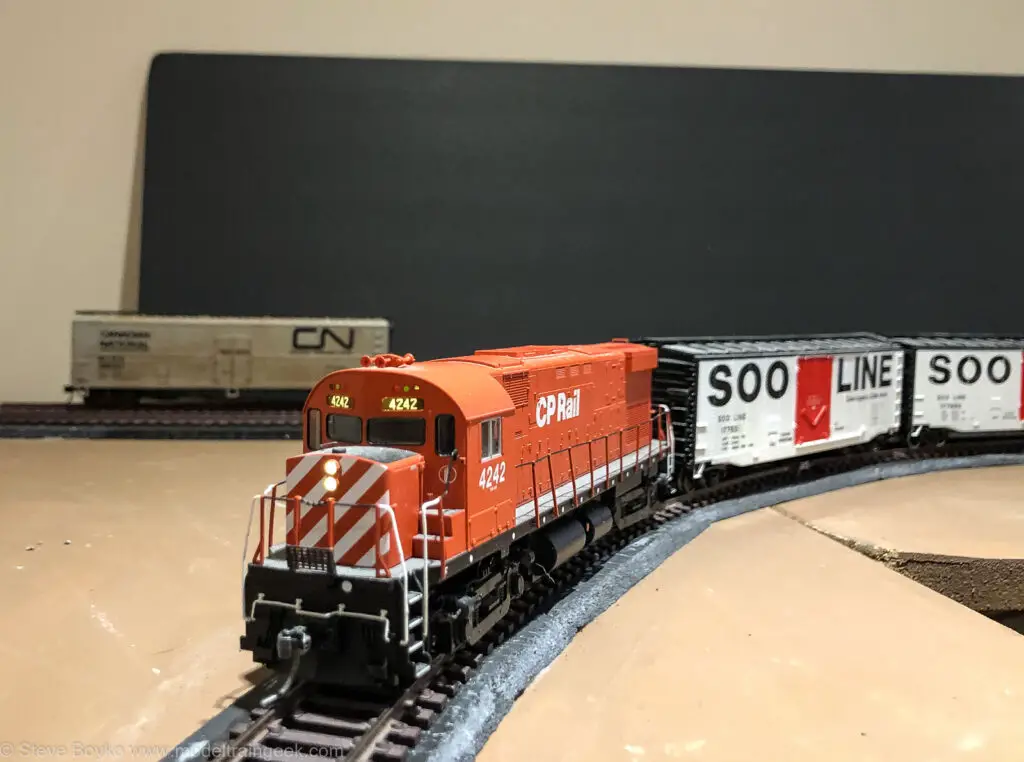 Model train passing a boxcar